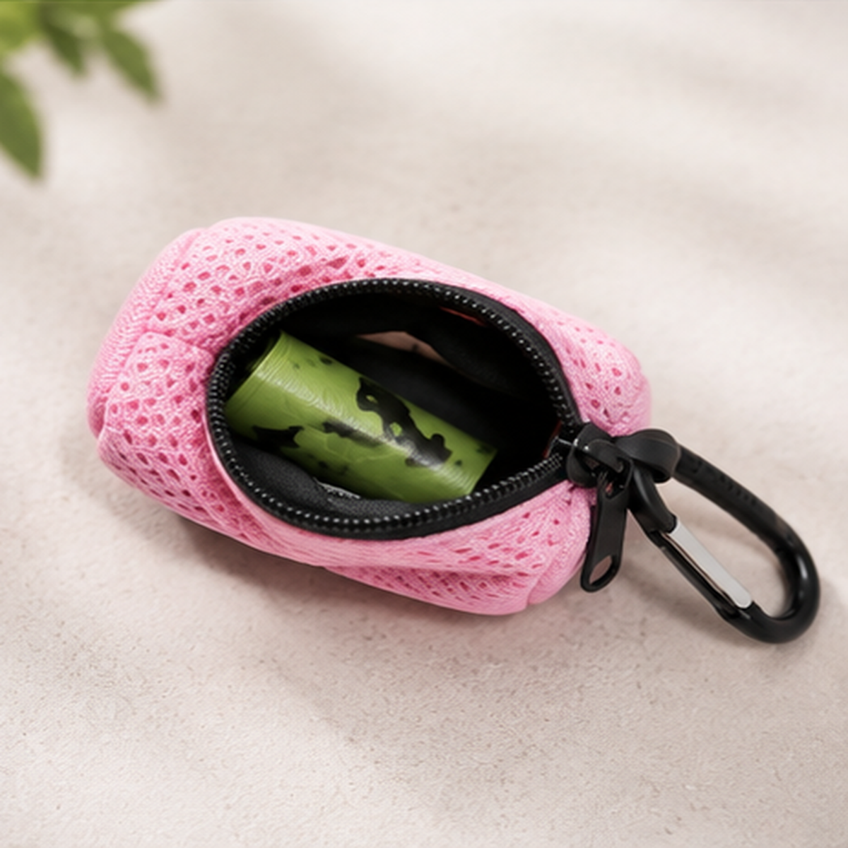 Open pink dog waste bag dispenser showing the bag roll inside